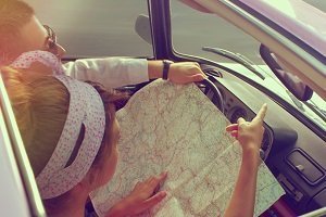 couple looking at map in car